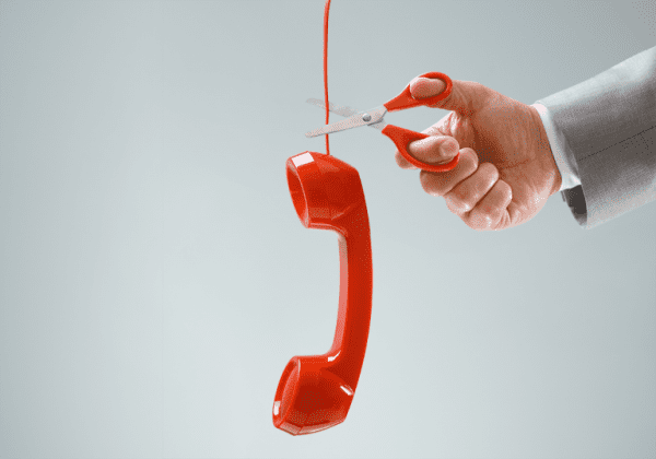 Red telephone cord being cut The PSTN switch off with First Class Comms